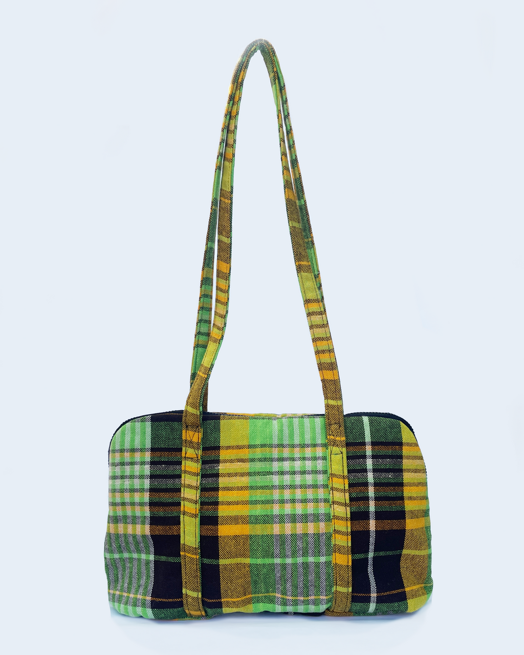 Green and yellow tartan patterned handbag on a white background