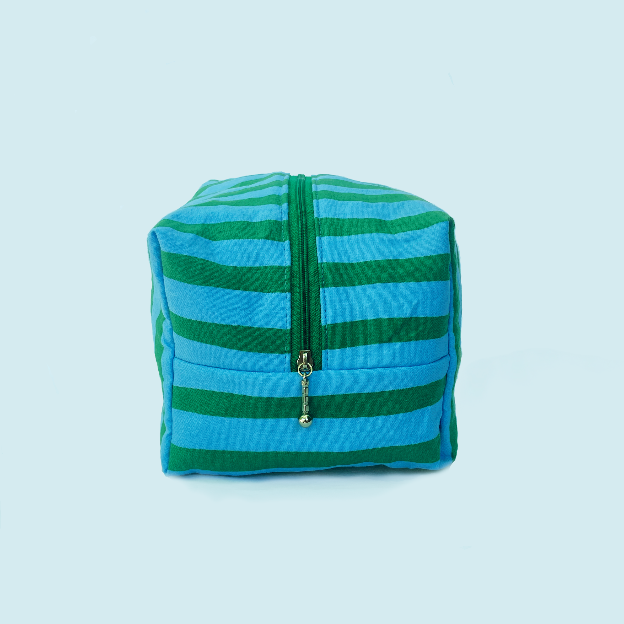 Green and blue striped pouch with a silver zipper on a white background