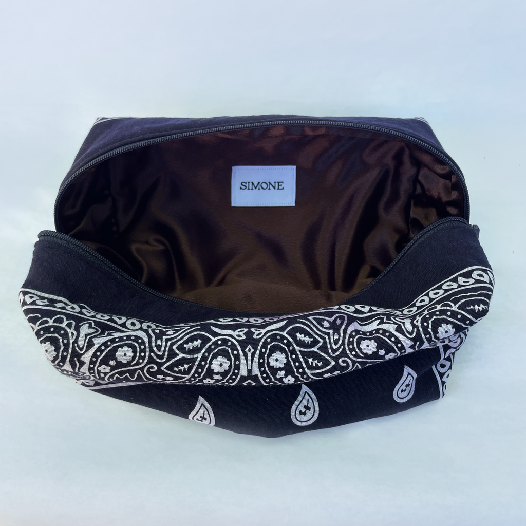 Navy bag with white paisley pattern on a white background