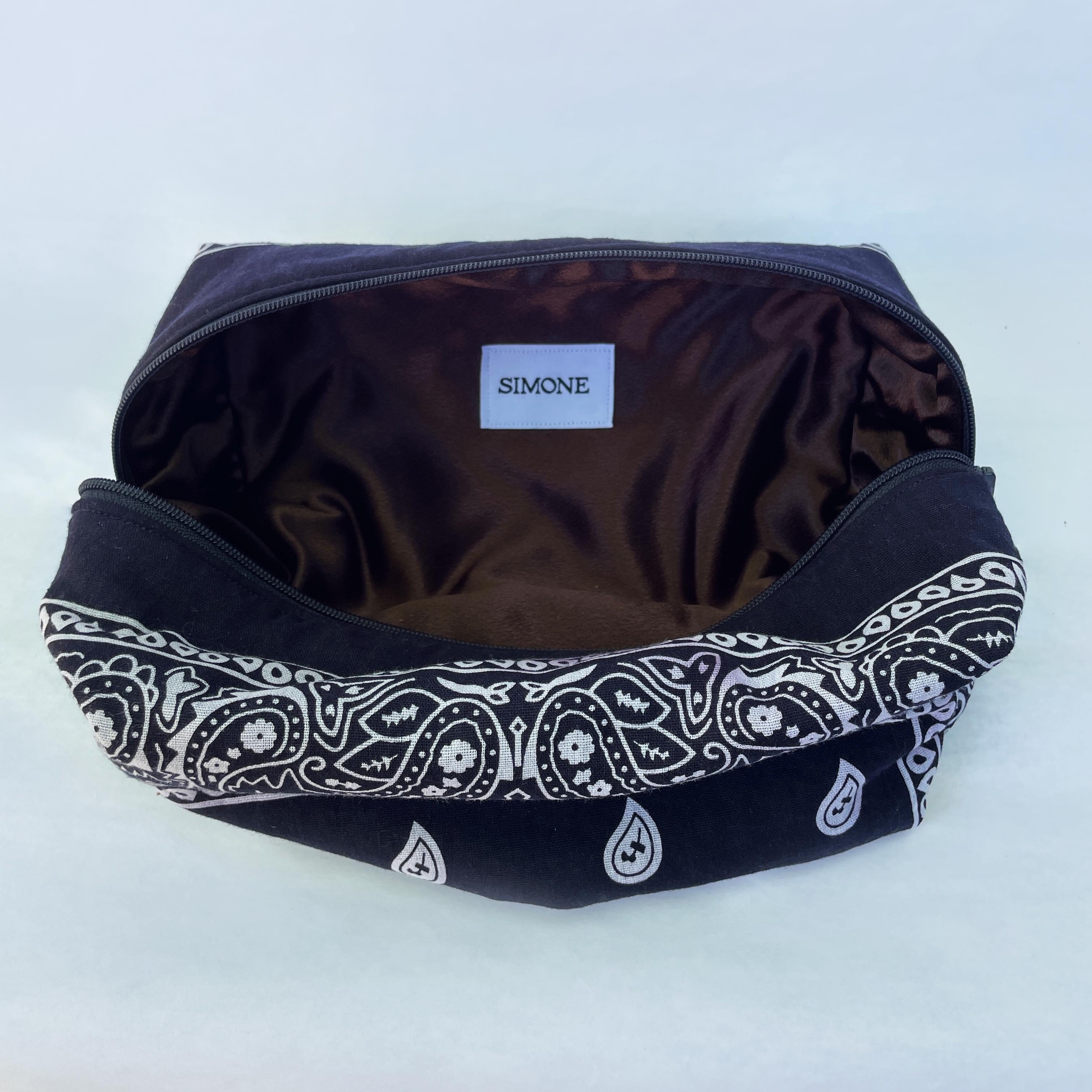 Navy bag with white paisley pattern on a white background